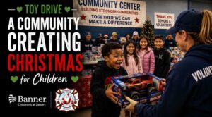 Volunteer presents a toy to a smiling child during Rockin' for Kids' annual holiday toy drive benefiting local children and families.