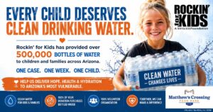 Smiling child holding bottled water promoting Rockin' for Kids Water Drive supporting Matthew's Crossing Food Bank in Arizona.