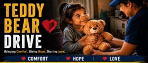 Child receiving a teddy bear through the Rockin' for Kids Teddy Bear Drive program in Arizona's East Valley.