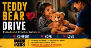 Child receiving a teddy bear through the Rockin' for Kids Teddy Bear Drive program in Arizona's East Valley.