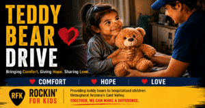 Child receiving a teddy bear through the Rockin' for Kids Teddy Bear Drive program in Arizona's East Valley.